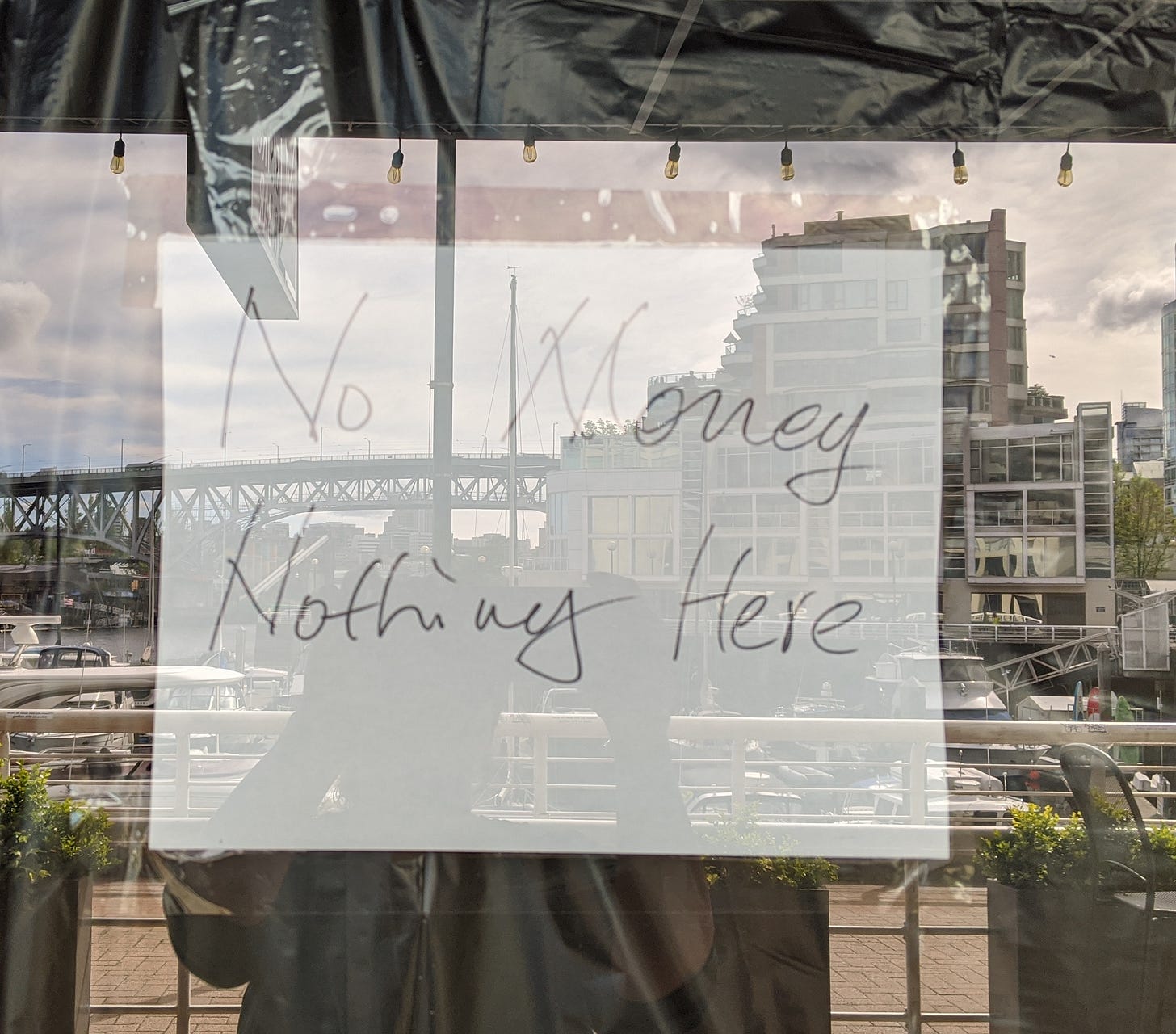 A window sign on the seawall in Vancouver reading "No Money, Nothing Here." A window sign on the seawall in Vancouver reading "No Money, Nothing Here."