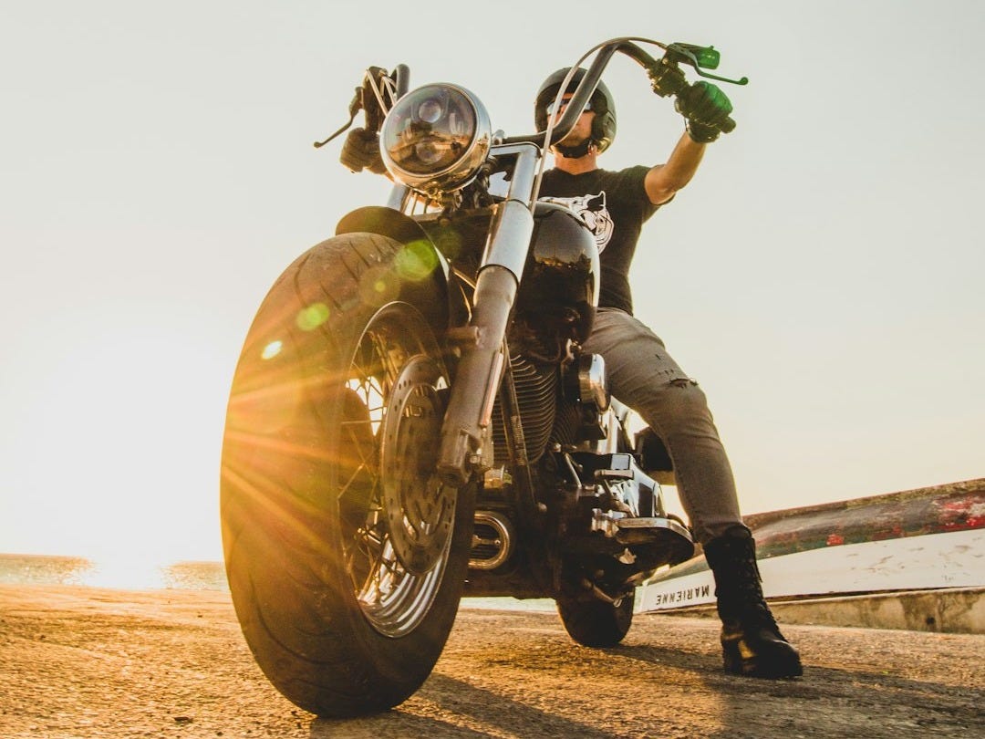 man in yellow helmet riding motorcycle during daytime