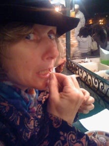 A person in a black hat eating

Description automatically generated