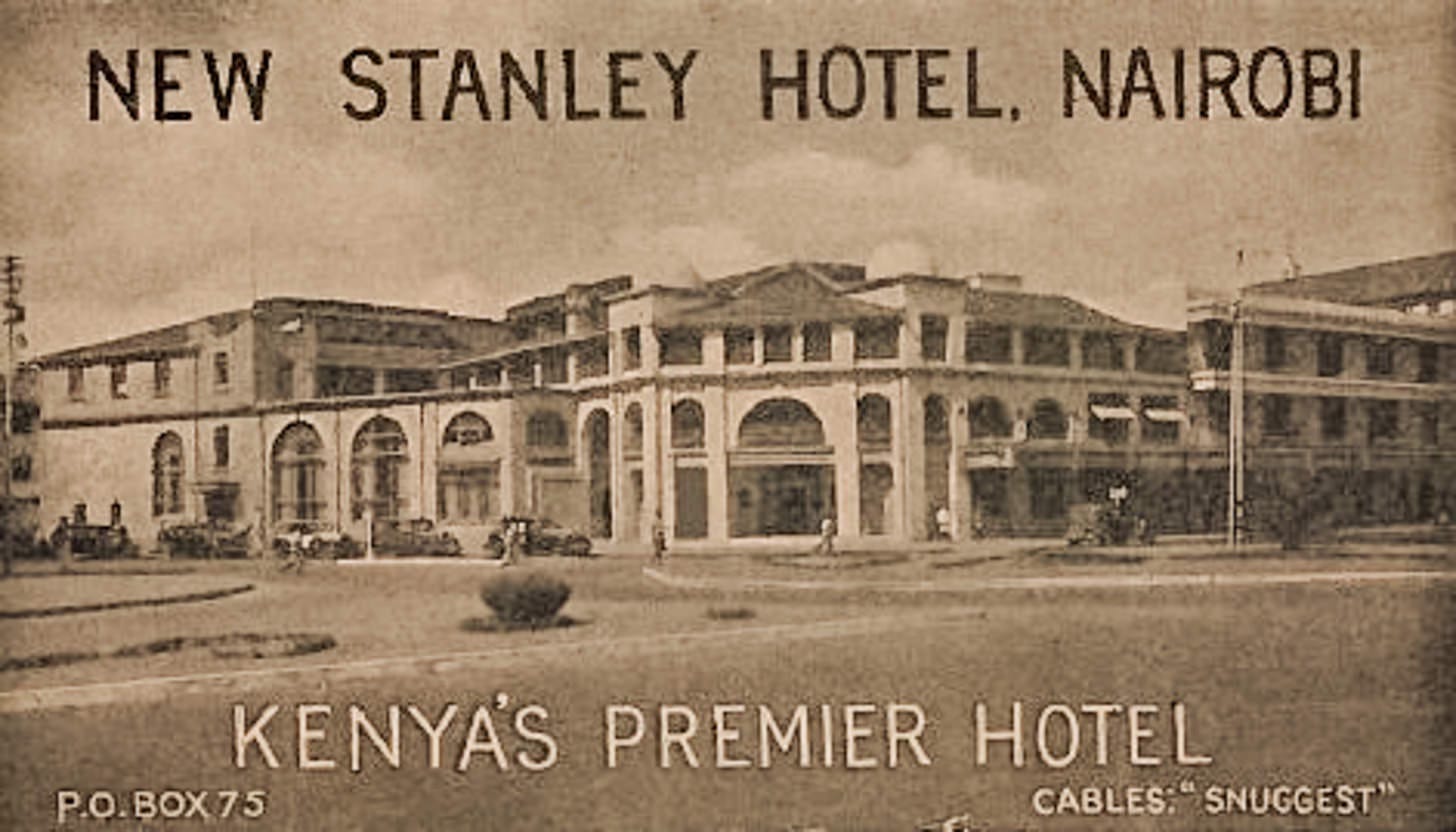 Vintage postcard showing large three-story white building with grand entrance