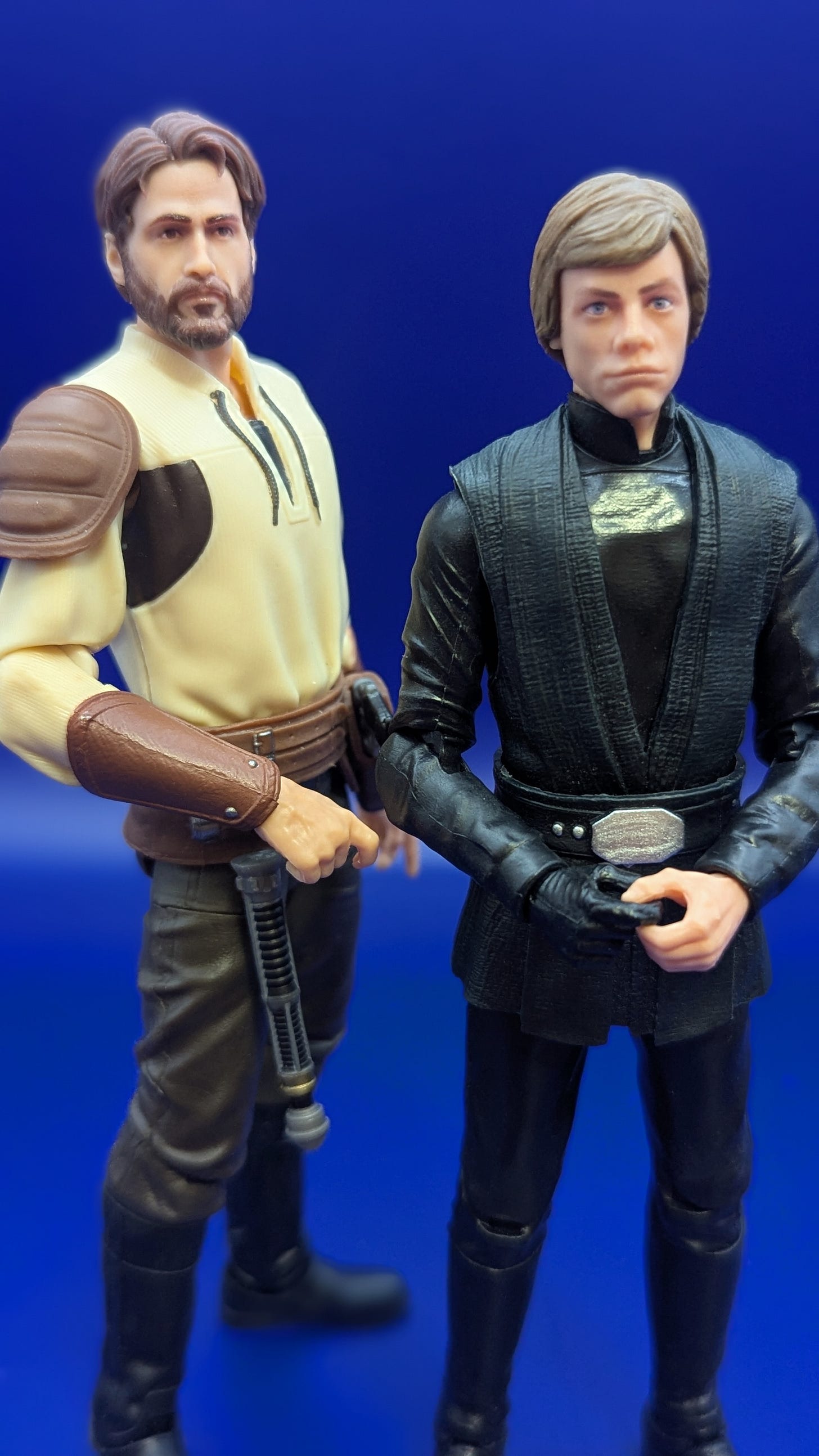 Star Wars: The Black Series Kyle Katarn standing beside Luke Skywalker, on a blue background Star Wars: The Black Series Kyle Katarn standing beside Luke Skywalker, on a blue background