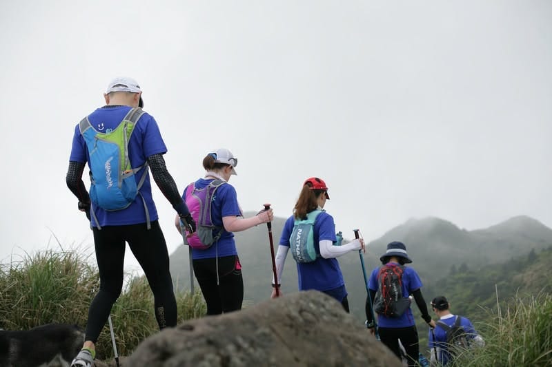 5 hikers on a trail