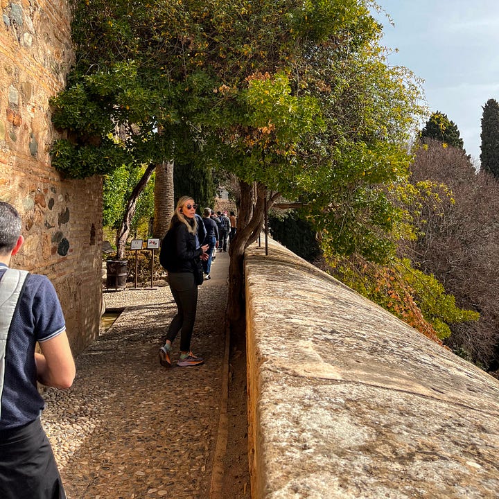 Author wandering the stone walls of the Alhambra