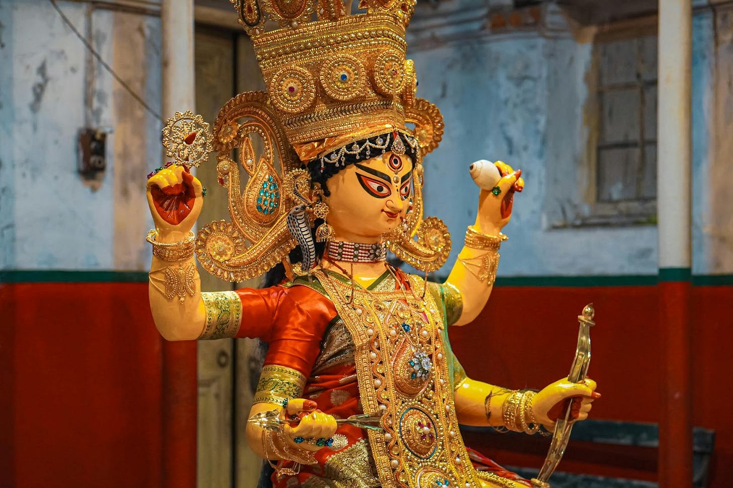 A beautifully crafted Goddess Durga idol in a vibrant traditional setup, reflecting cultural artistry.