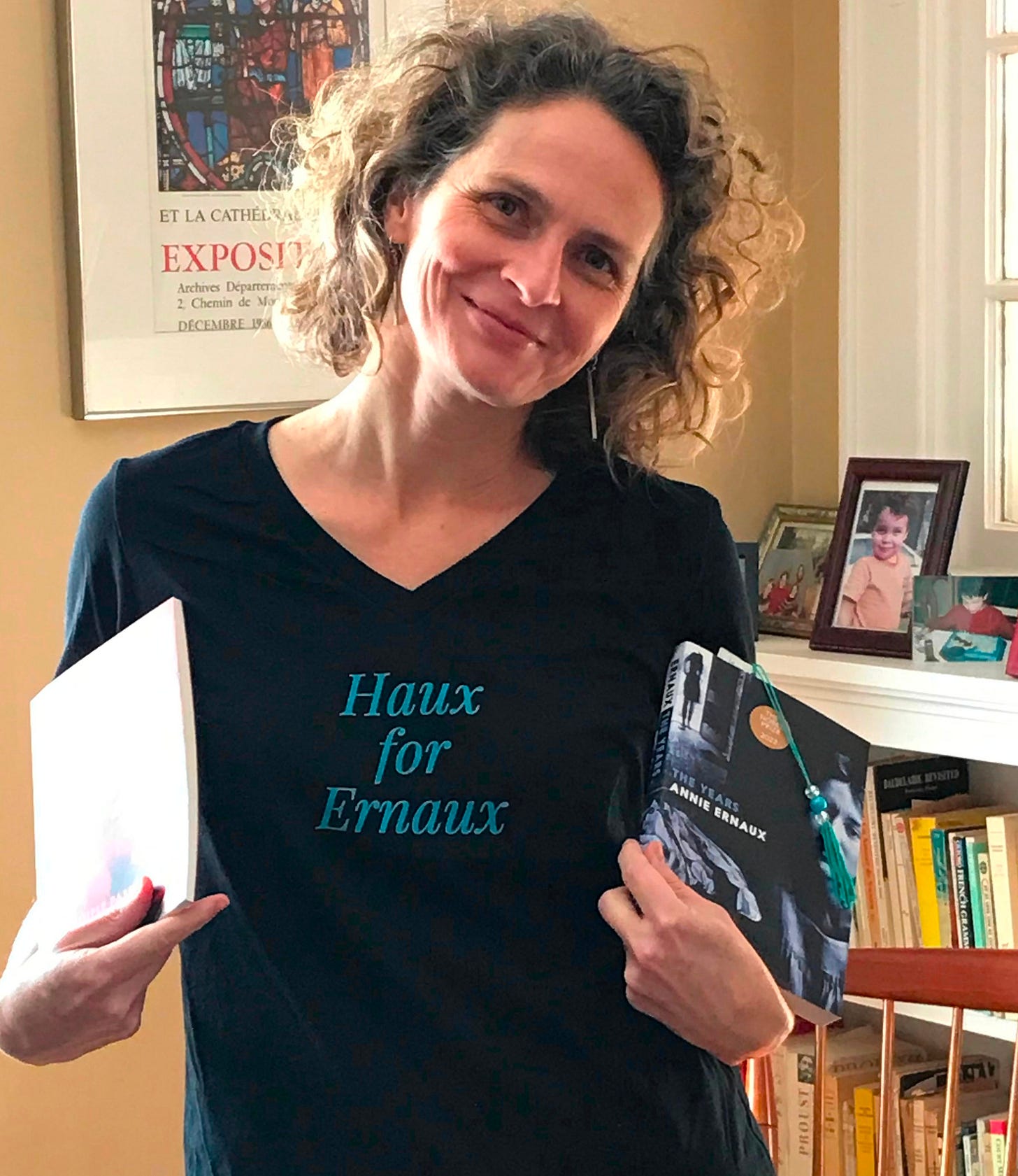 author wearing "Haux for Ernaux" t-shirt and holding Ernaux books author wearing "Haux for Ernaux" t-shirt and holding Ernaux books