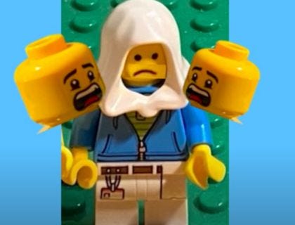 LEGO NUN WITH TWO LEGO ANGRY FACES ON SHOULDER