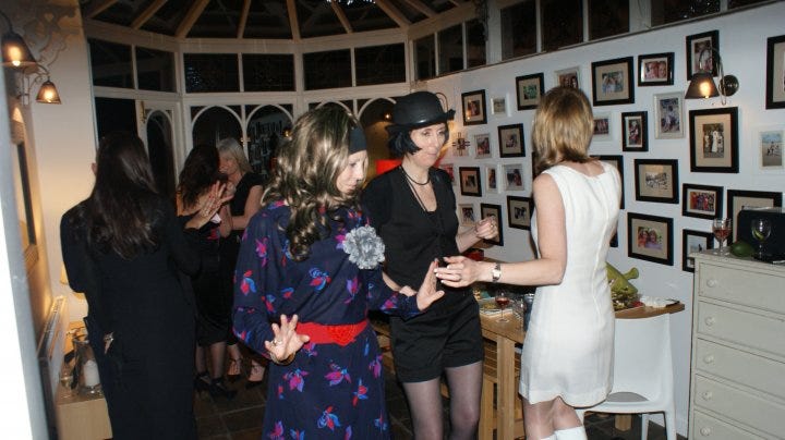 My family gallery wall (mid party). Yes, I am dressed as Margot from The Good Life. Allegedly.