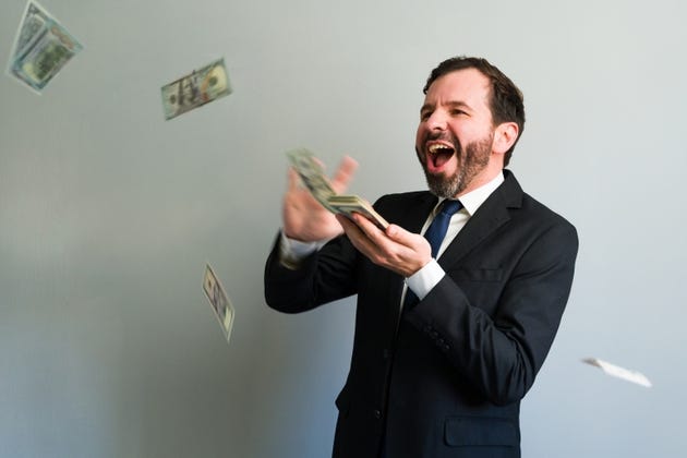 Happy businessman throwing money and making it rain in celebration of success Happy businessman throwing money and making it rain in celebration of success
