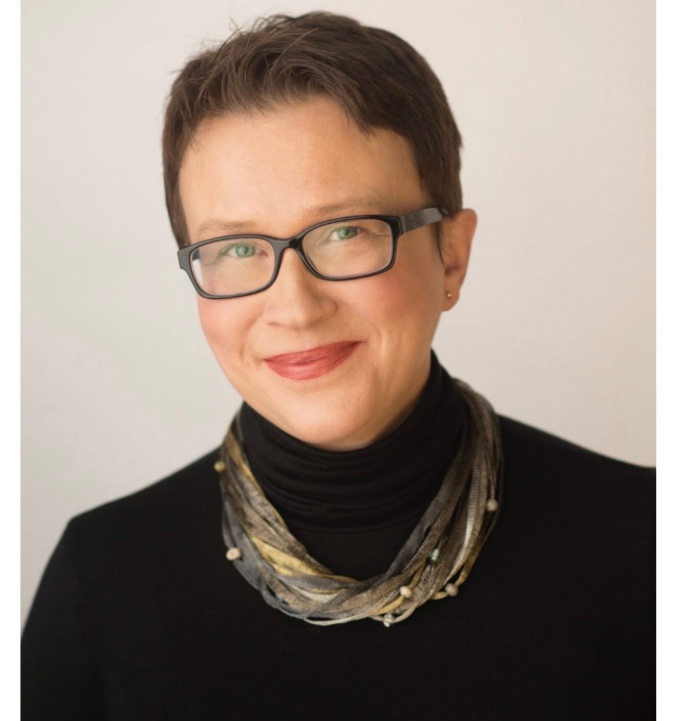 May be an image of one or more people, eyeglasses and scarf