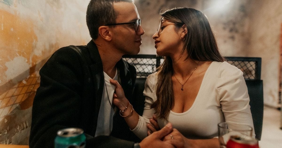 A couple sharing an intimate moment in a cozy Buenos Aires cafe