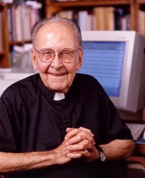 Walter ong, in advanced age, smiles warmly at the camera. He wears a short-sleeved priest's shirt and collar. Walter ong, in advanced age, smiles warmly at the camera. He wears a short-sleeved priest's shirt and collar.