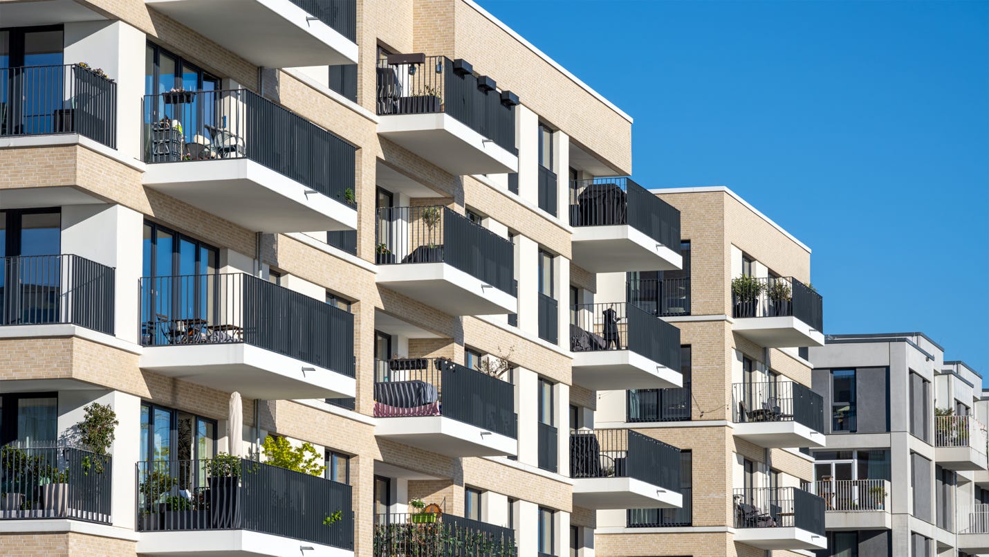A building with balconies and windows

Description automatically generated