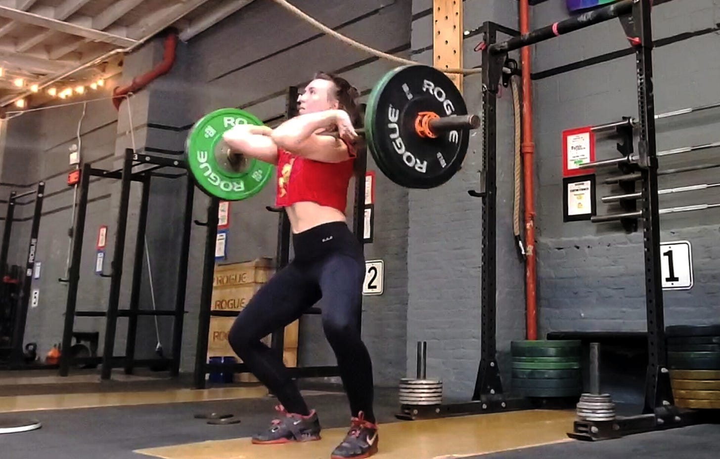 The author catching a barbell in a power clean position