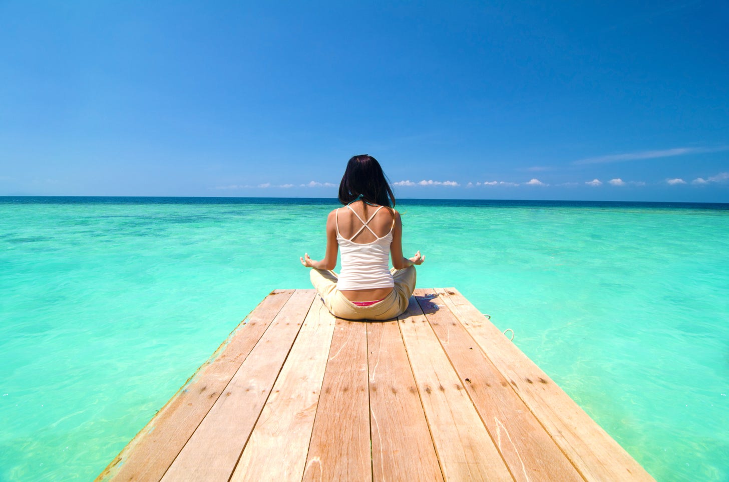 girl meditating at beach