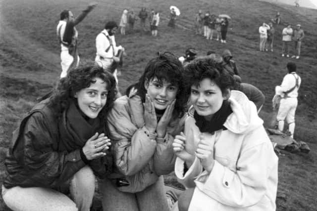 Three girls wash their face in the morning dew at the top of Arthur's Seat during the traditional May Day ceremony in Edinburgh, 1987. Three girls wash their face in the morning dew at the top of Arthur's Seat during the traditional May Day ceremony in Edinburgh, 1987.