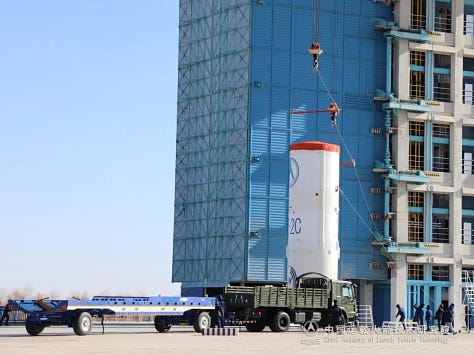 The Long March 2C's second-stage and fairing being placed atop of the launch vehicle.