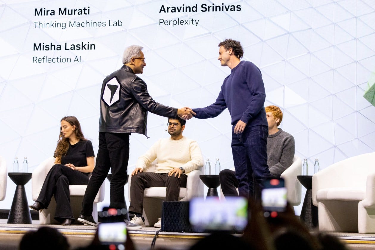 Jensen Huang shaking hands with Misha Laskin on stage at NVIDIA GTC.