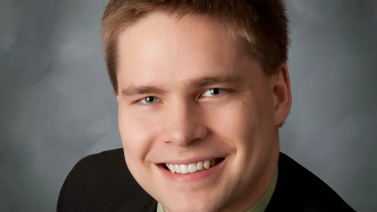 close up of man smiling inside