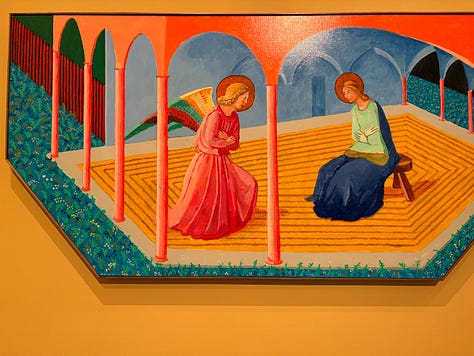 Multiple bright-colored paintings including a self-portrait of Hockney in a yellow plaid suit and big yellow glasses, the crowd viewing paintings, a mother and child in front of a bright painting of a massive tree, an annunciation painting redone in neon colors, a green lawn with sprinkler spray, a photograph of hockney working at his drawing table with his little terrier dog under the table and two paintings with raindrops hitting puddles among trees