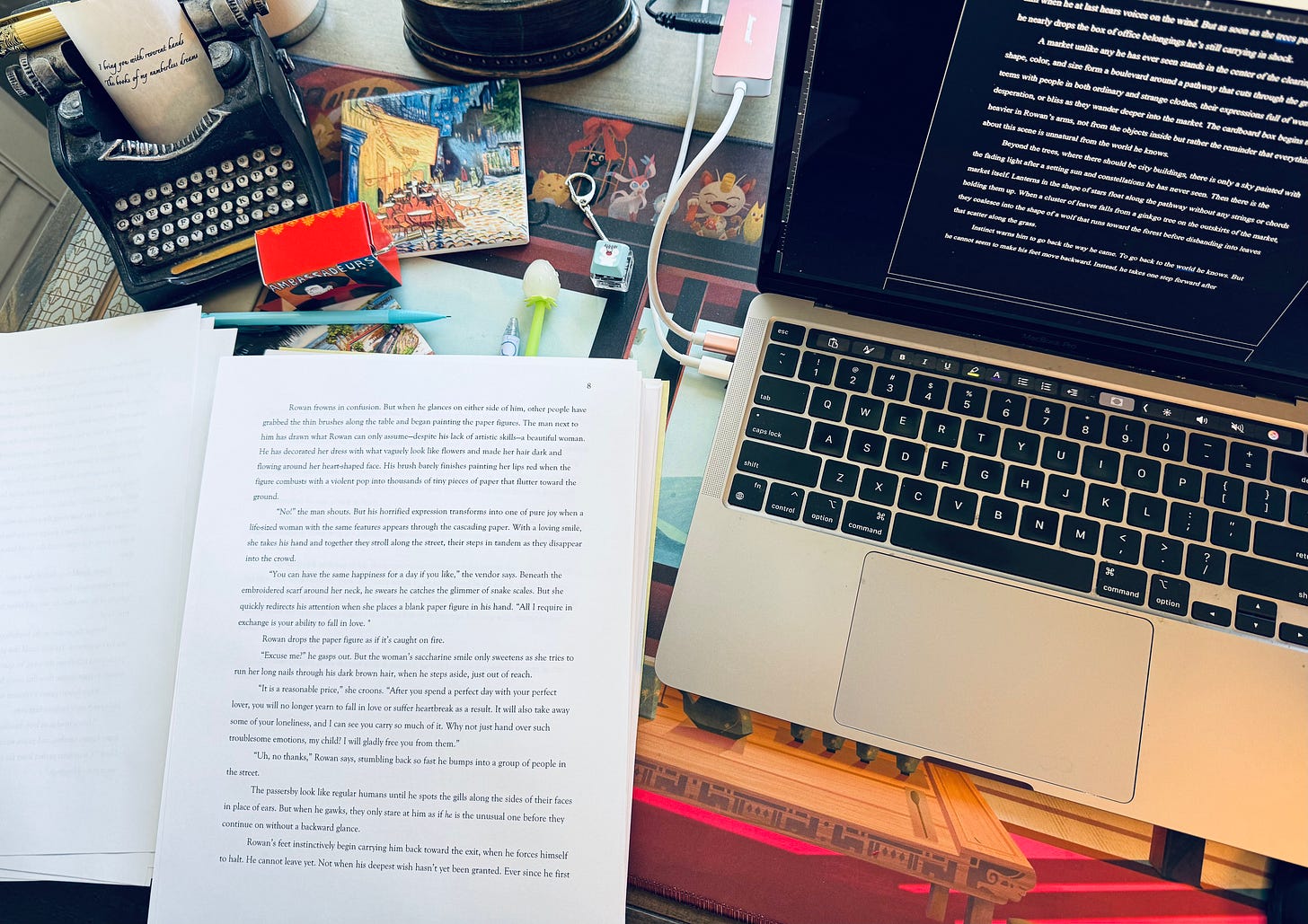 photo of my writing desk with my computer, printed pages, a typewriter decoration, a french coaster, and a music box photo of my writing desk with my computer, printed pages, a typewriter decoration, a french coaster, and a music box