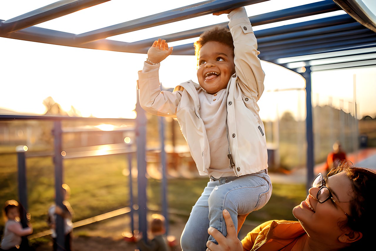 child on monkey bars showing the playfulness we can learn from kids
