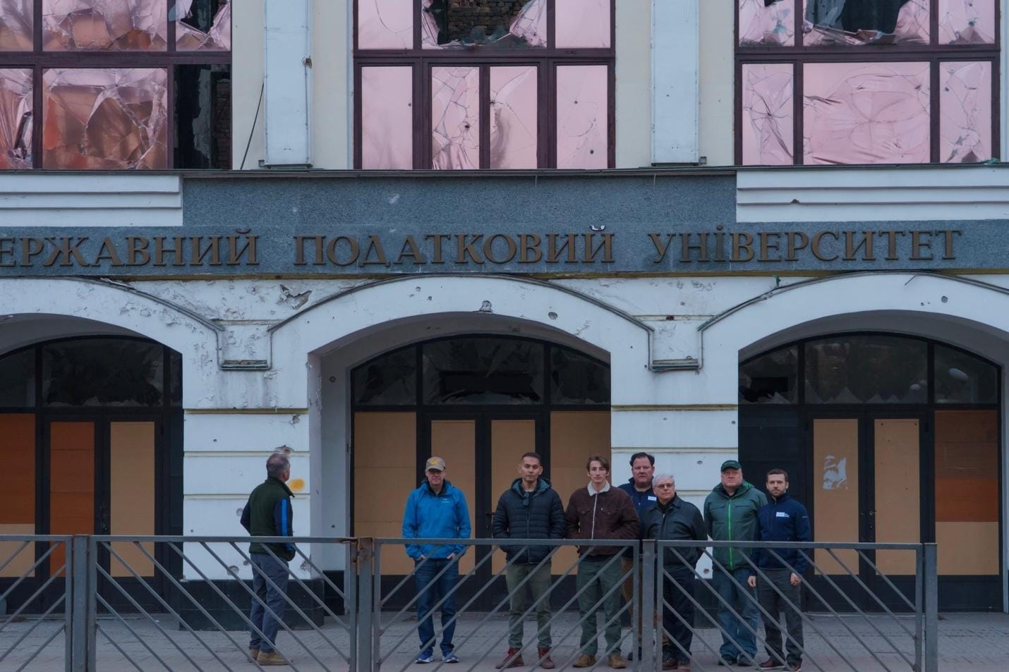 A group of people standing in front of a building

AI-generated content may be incorrect.