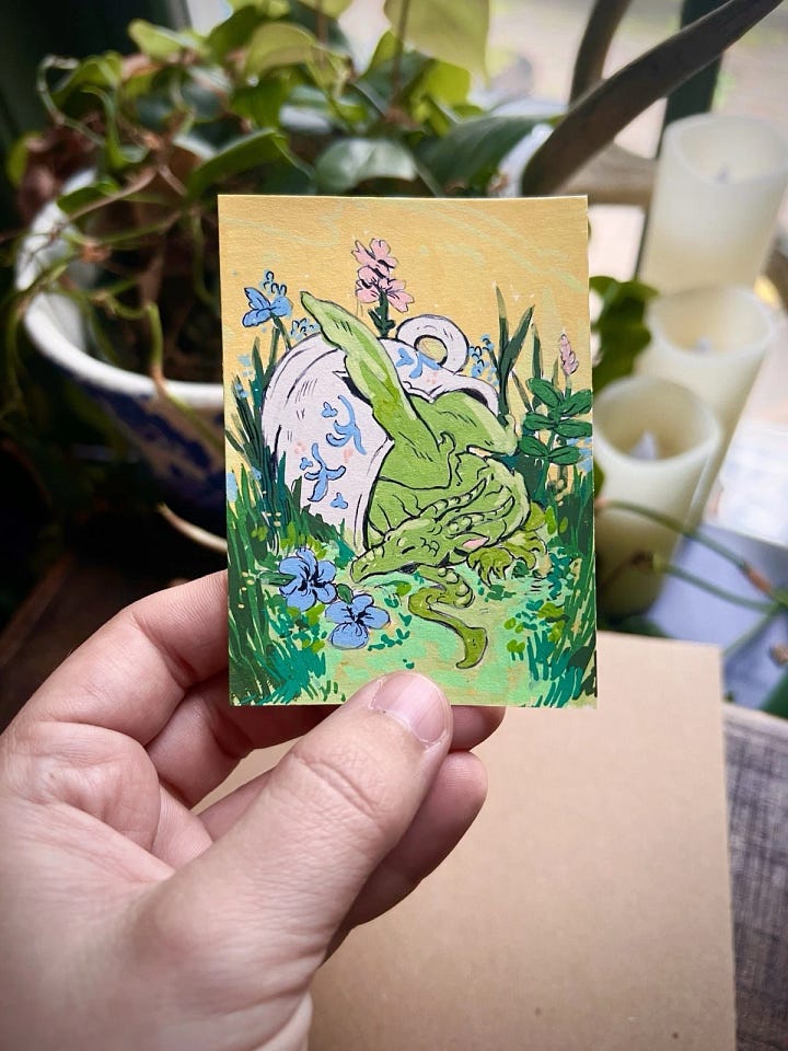 First photo: a sticker of a fat puffin.  Second photo: a hand painted ACEO of a dragon in a tea cup.