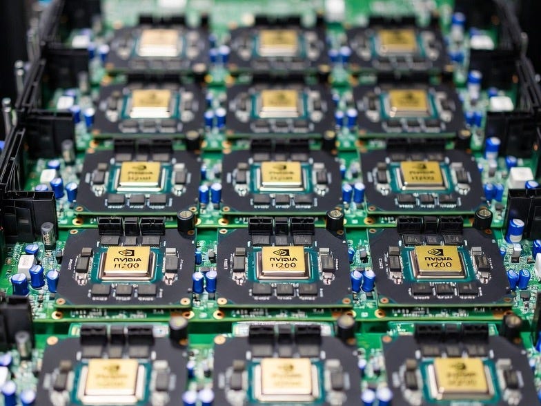 A photograph of multiple Nvidia H200 GPU chips arranged on a server motherboard in a data center. A photograph of multiple Nvidia H200 GPU chips arranged on a server motherboard in a data center.