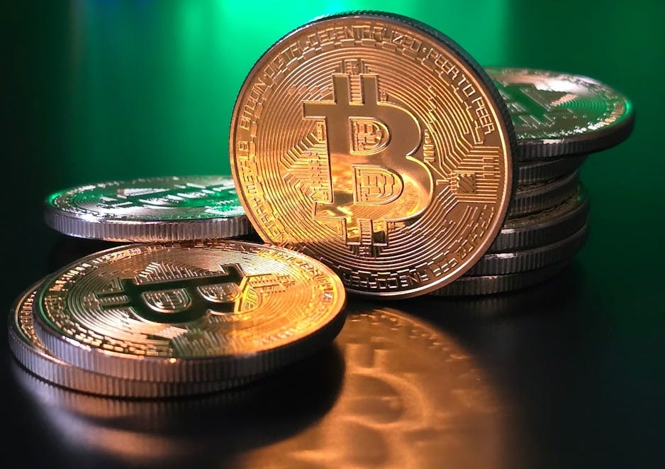 a pile of bitcoins sitting on top of a table a pile of bitcoins sitting on top of a table