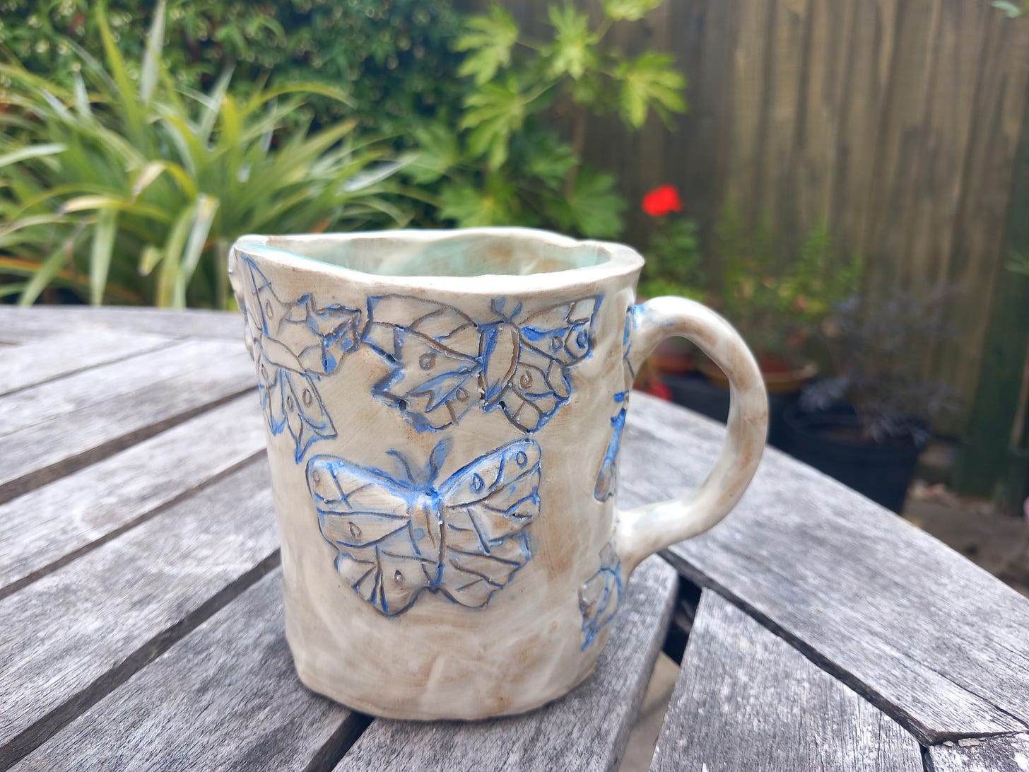 White mug with butterflies outlined in blue