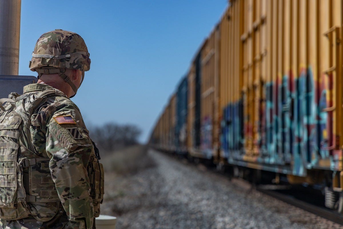 A National Guardsman assigned to the US Southern Border inspects railcars for contraband or illegal aliens placed aboard them by the cartels A National Guardsman assigned to the US Southern Border inspects railcars for contraband or illegal aliens placed aboard them by the cartels