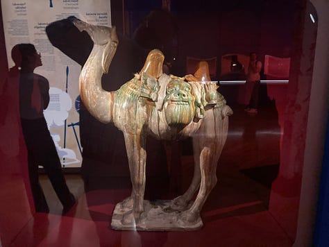 Pictures of a ceramic camel, a pizza, the seal of a General, a Garuda mask, a yurt, a lovely lady looking at a Yama, a map, and a timeline.