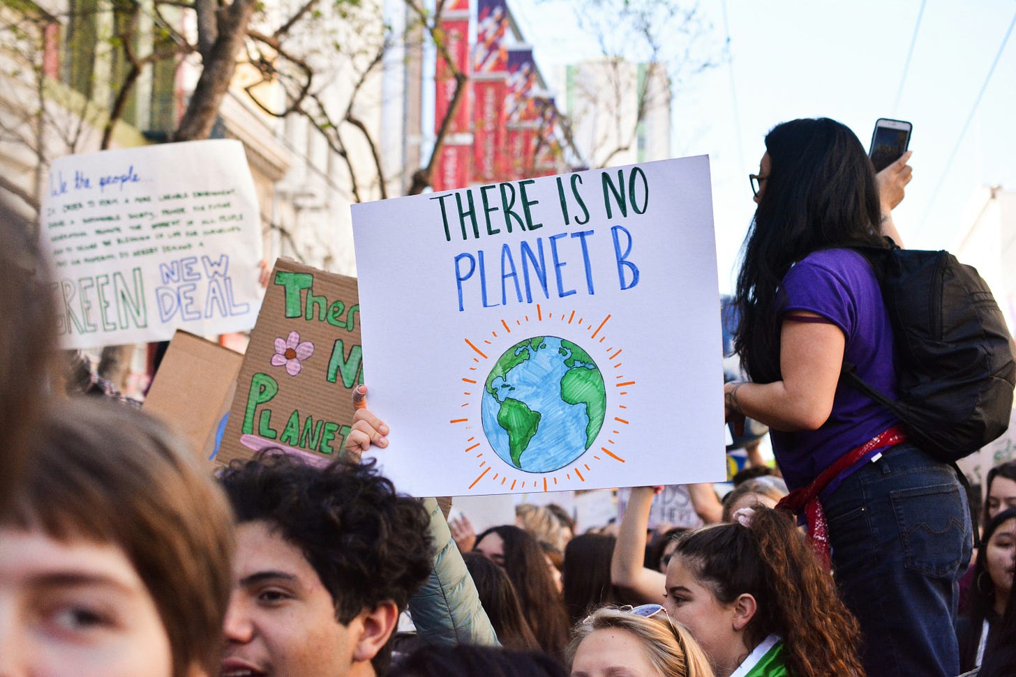 Young climate protestors with placard that reads "There is no planet B"