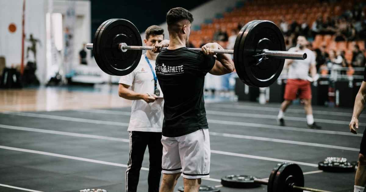 man in a weightlifting competition about to perform a front squat man in a weightlifting competition about to perform a front squat