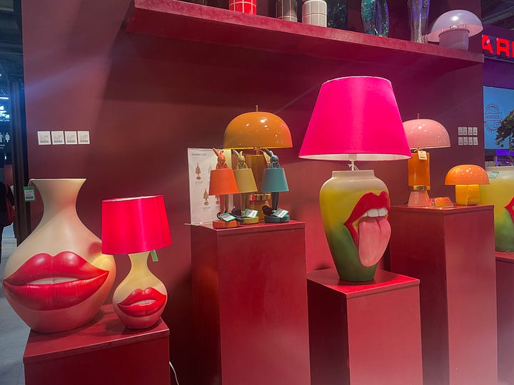 Playful tabletop lighting display at Maison & Objet Paris 2026 featuring bold sculptural lamps, saturated colors, glossy finishes, and pop-art inspired forms. Colorful sculptural decor figure at Maison & Objet Paris 2026 with hand-painted patterns, high-gloss finish, and whimsical contemporary design.