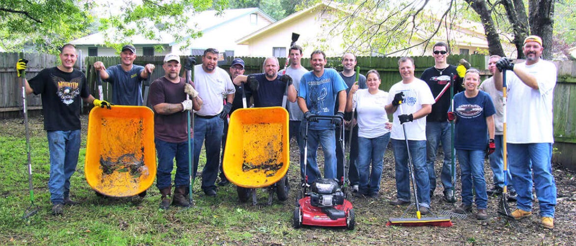 neighborhood cleanup volunteers pose for a photo with their equipment neighborhood cleanup volunteers pose for a photo with their equipment