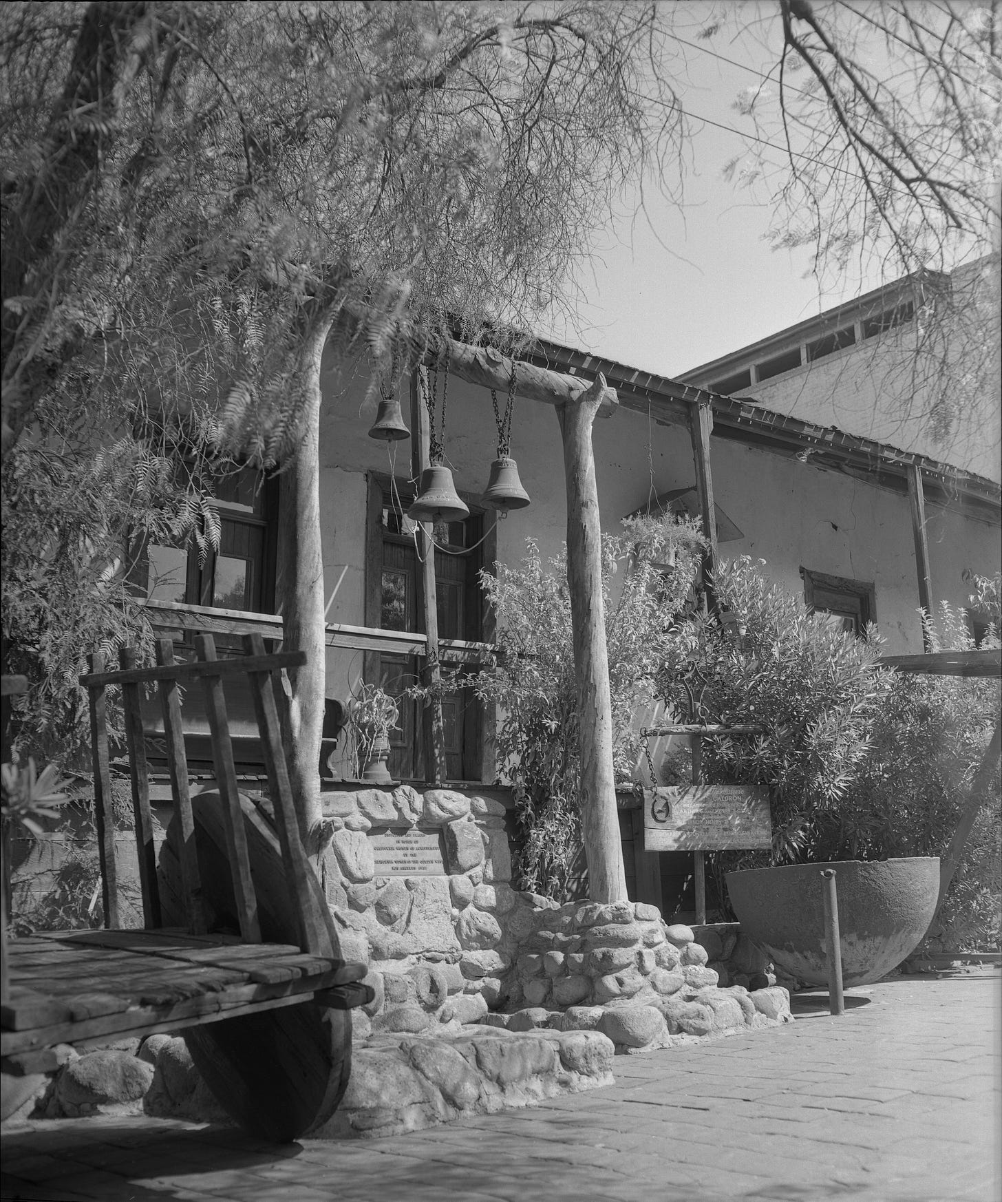 The historic Avila Adobe on Olvera Street, Los Angeles, with mission bells and a stone marker. Built 1818. The historic Avila Adobe on Olvera Street, Los Angeles, with mission bells and a stone marker. Built 1818.
