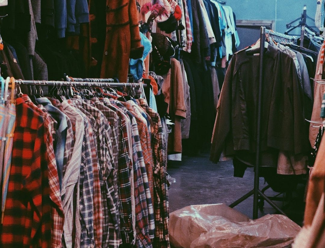 assorted clothes on clothes stand assorted clothes on clothes stand