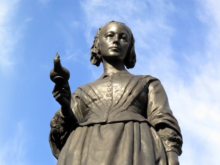 Memorial statue of Florence Nightingale against a blue sky. Memorial statue of Florence Nightingale against a blue sky.