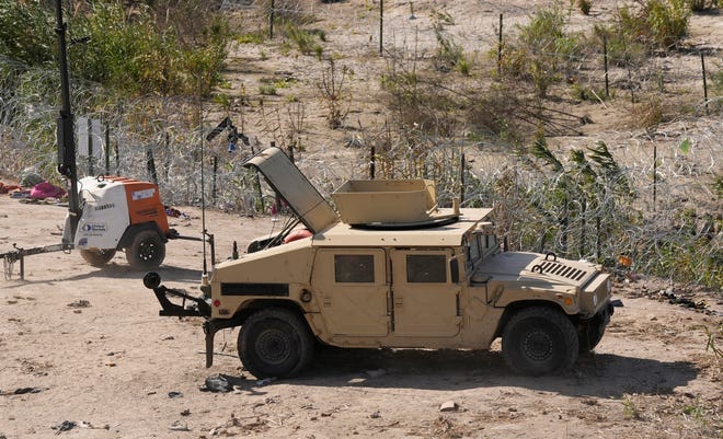 A military Humvee is parked next to concertina wire in Shelby Park in Eagle Pass on Monday. The state officially seized control of the city park late Wednesday. A military Humvee is parked next to concertina wire in Shelby Park in Eagle Pass on Monday. The state officially seized control of the city park late Wednesday.
