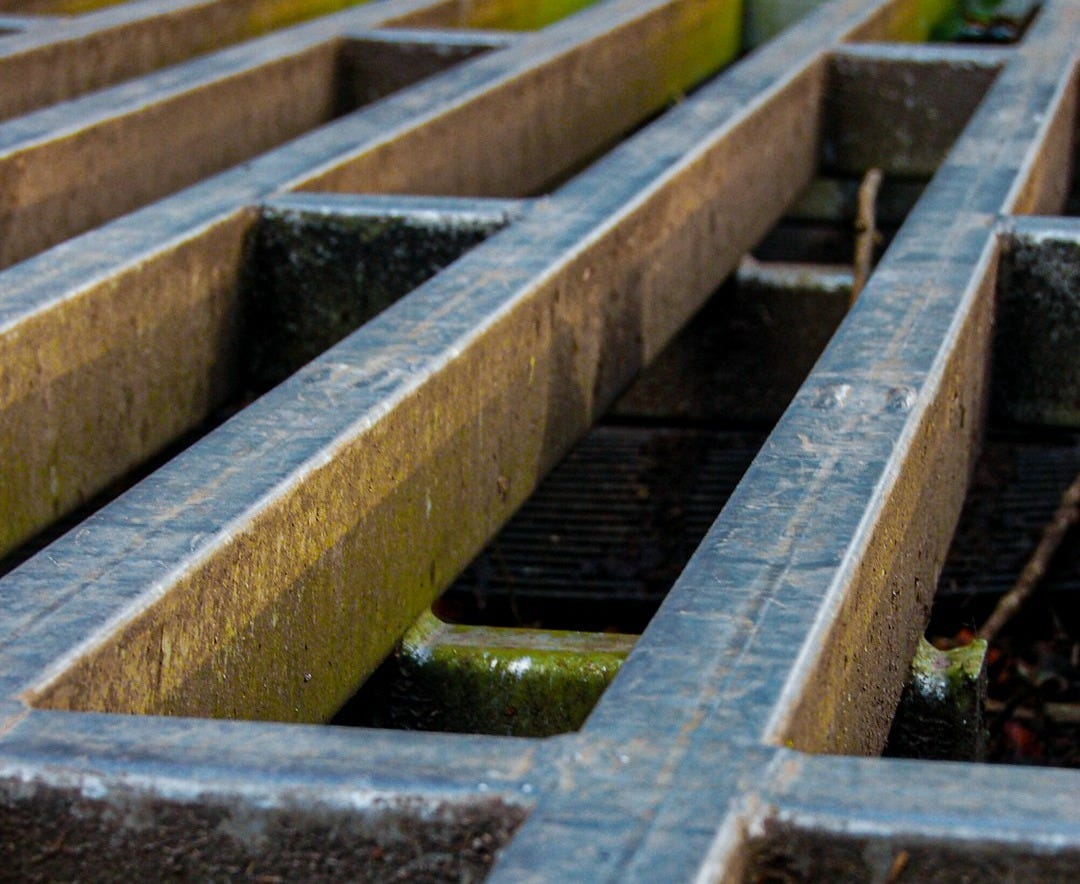 a close up of a metal grate in the ground