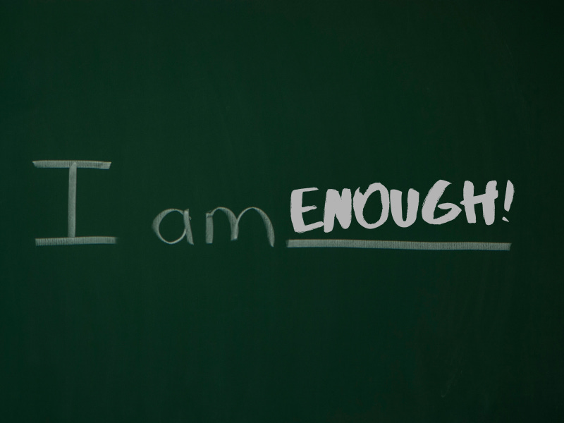 A chalkboard on which is written, "I am enough"