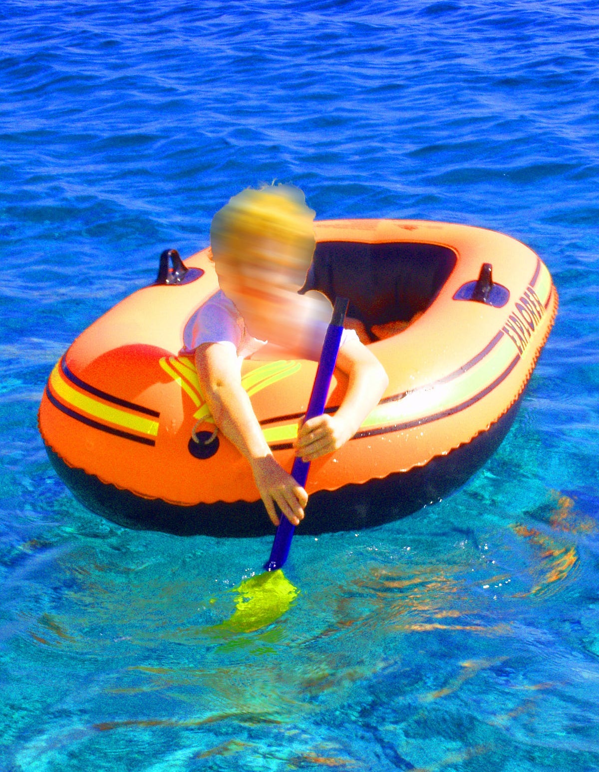 Photo of a boy in an inflatable dinghy.