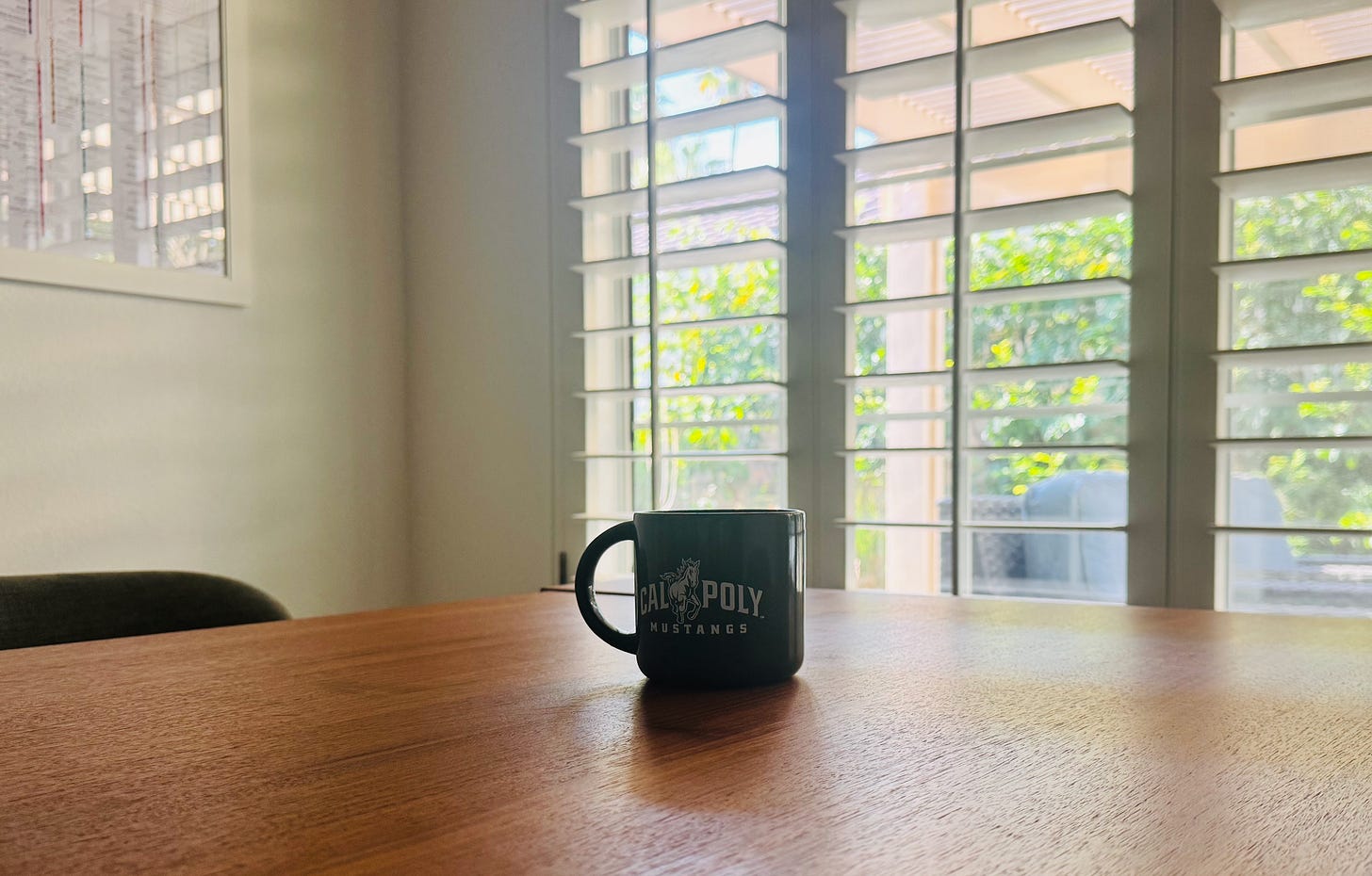 A coffee cup left on the table after an early morning, sun shining in from the window onto the table. A coffee cup left on the table after an early morning, sun shining in from the window onto the table.