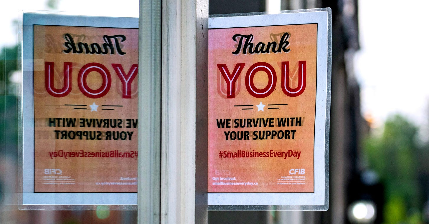 photo of a sign on a building window reading "Thank You, we survive with your support". The sign is reflected in an adjacent window. photo of a sign on a building window reading "Thank You, we survive with your support". The sign is reflected in an adjacent window.