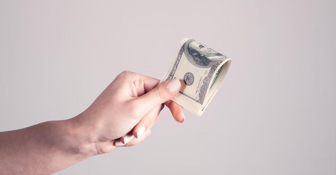 person holding 1 us dollar bill