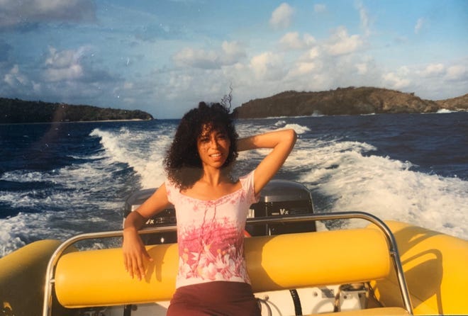 Lisa Phillips, age 21, pictured in a boat on her way to Epstein's island, where she says Epstein sexually assaulted her.