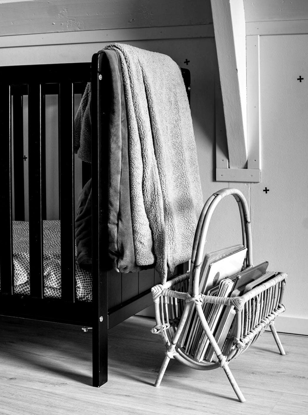 blue bath towel on white wooden crib