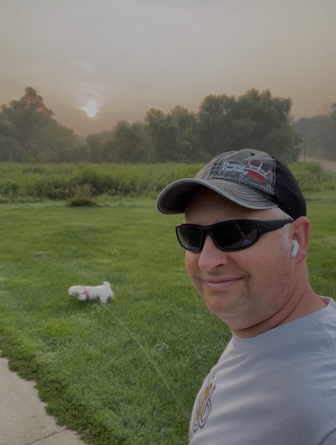 Dr. Dave walking his dog through the Dordt prairie at sunrise