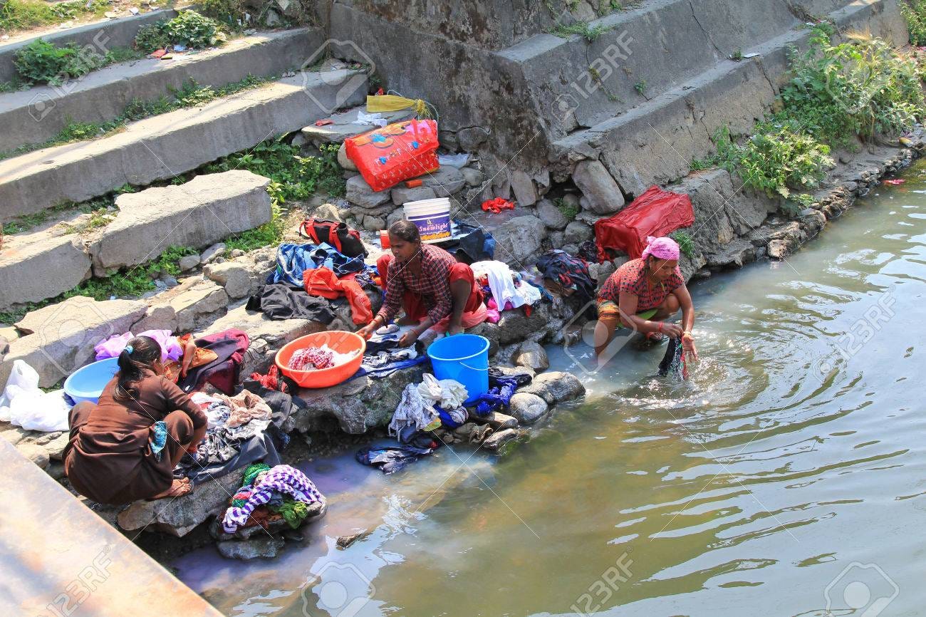 Nepalese Women Washing Clothes Along The River In Pokhara City,.. Stock  Photo, Picture And Royalty Free Image. Image 34360566.